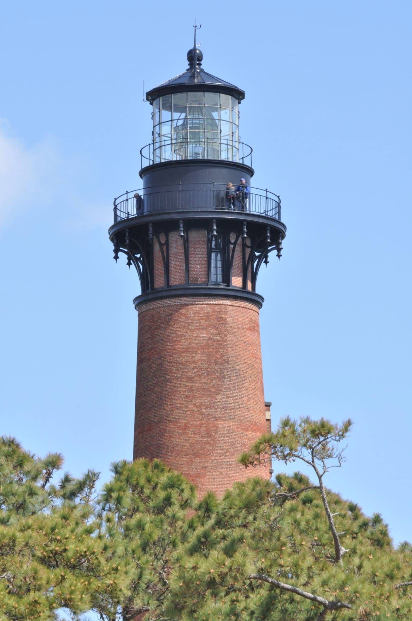 Currituck Beach Lighthouse rising above the trees in Corolla