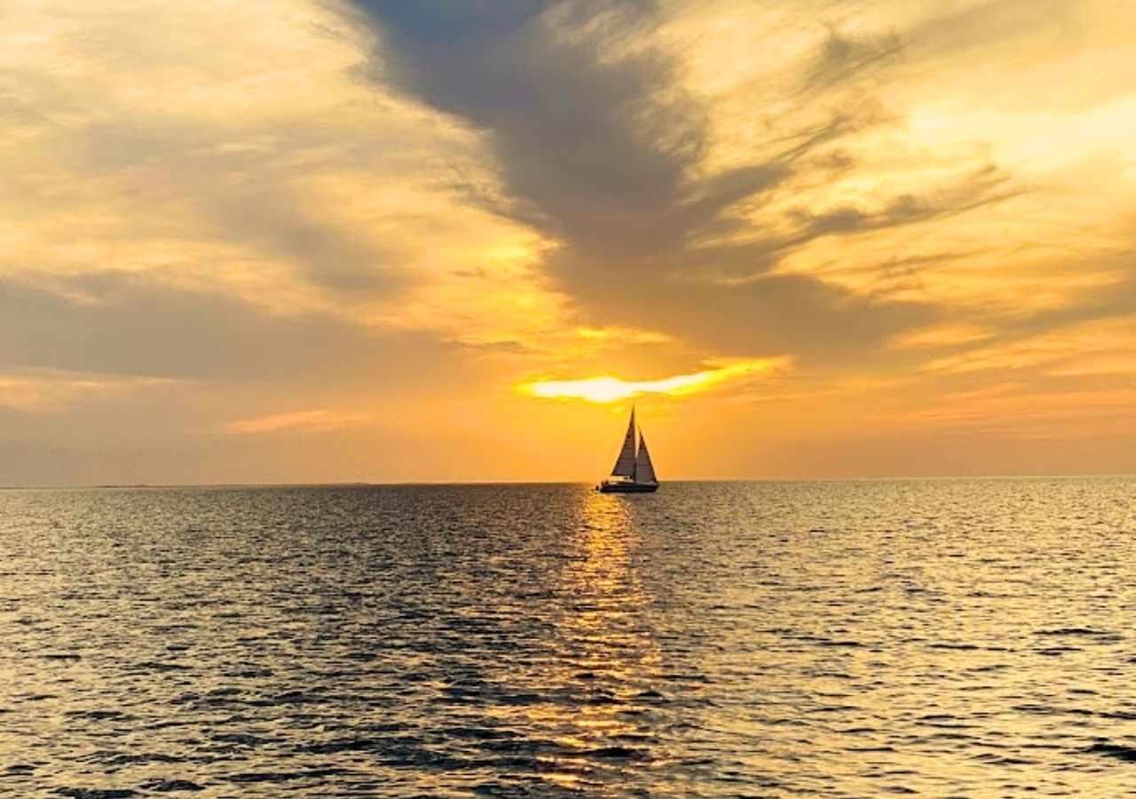 Sailboat at sunset over the sound in the Outer Banks