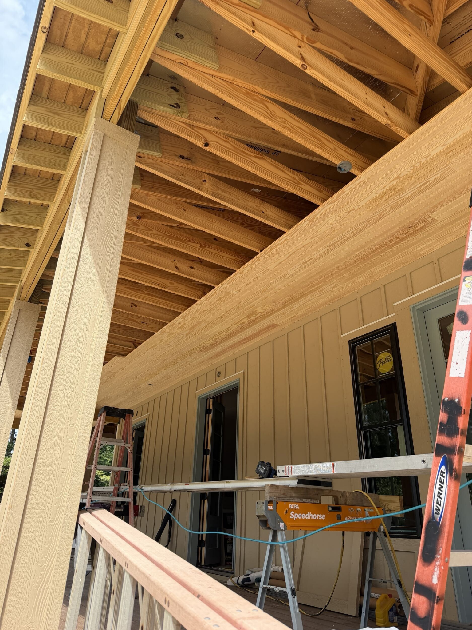 Covered porch framing and wrapped columns on a custom home under construction in Southern Shores