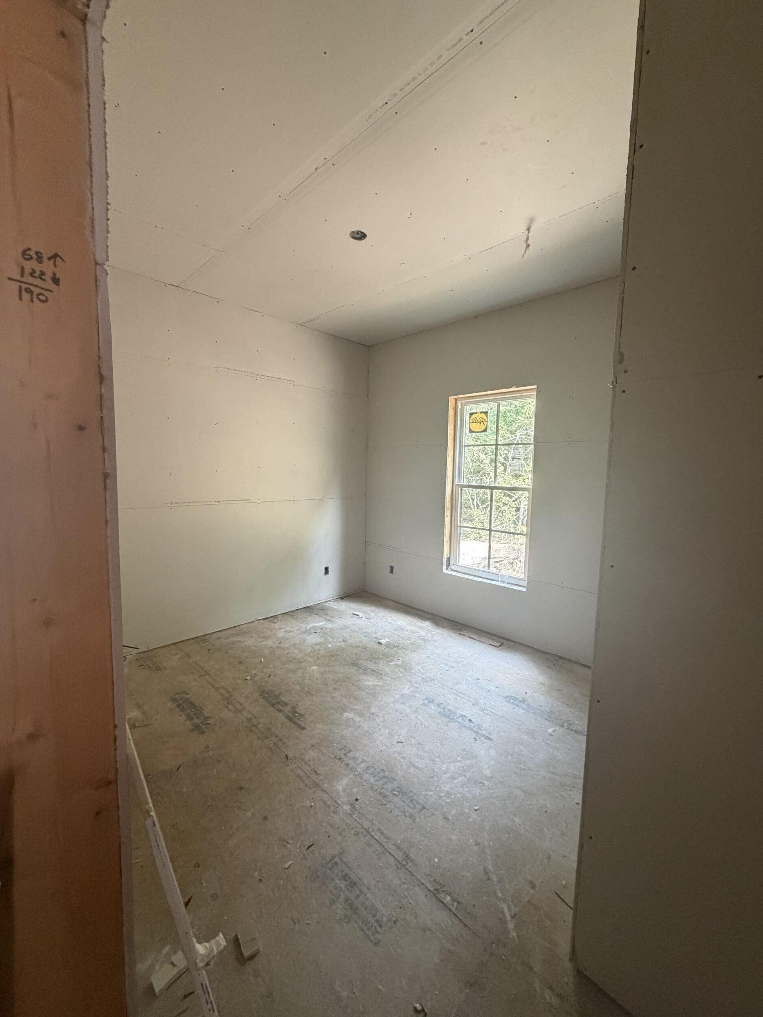 Interior room with newly installed drywall in a Southern Shores custom home under construction