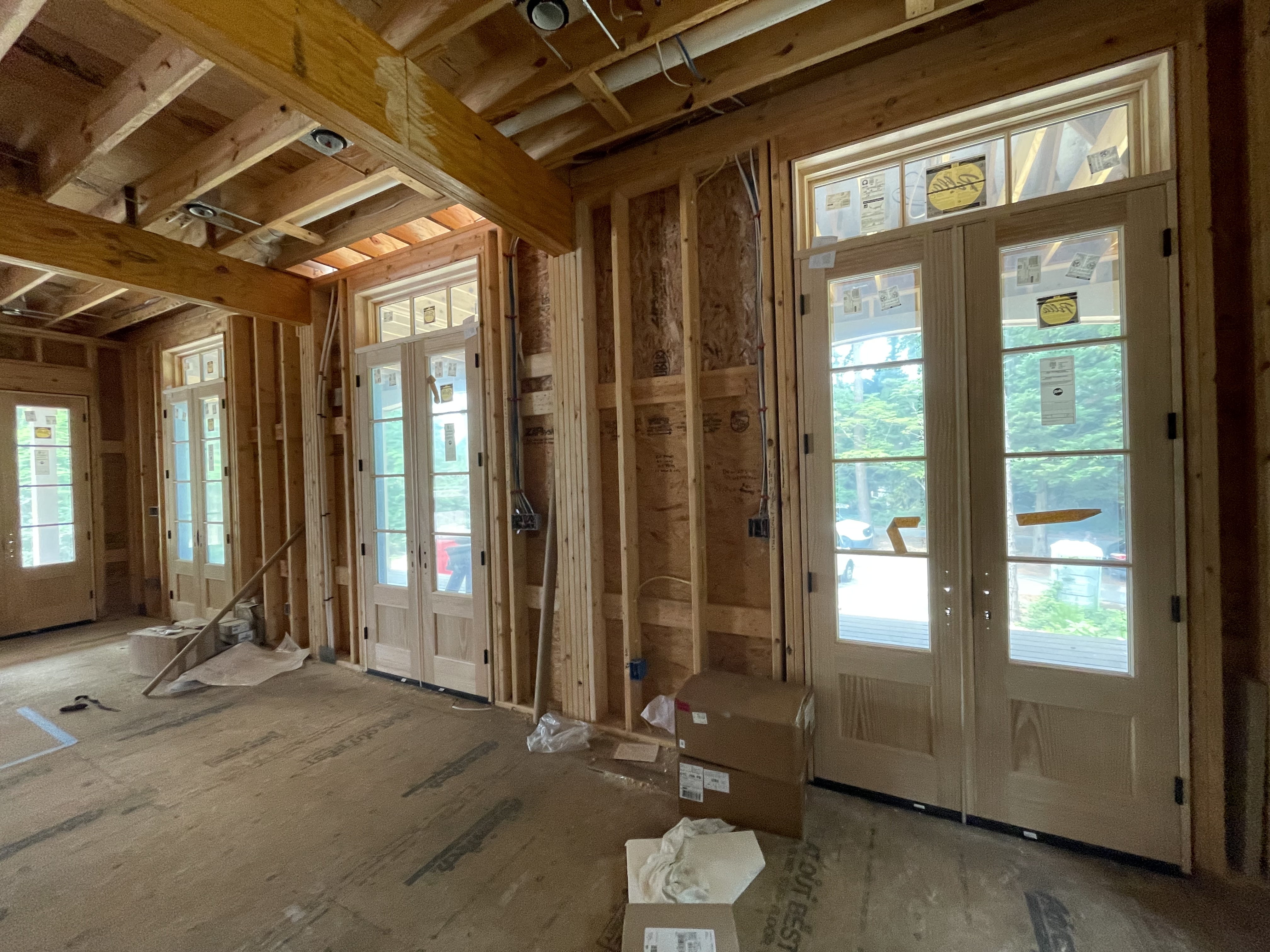 Interior framing of a custom home in Southern Shores with large windows and doors