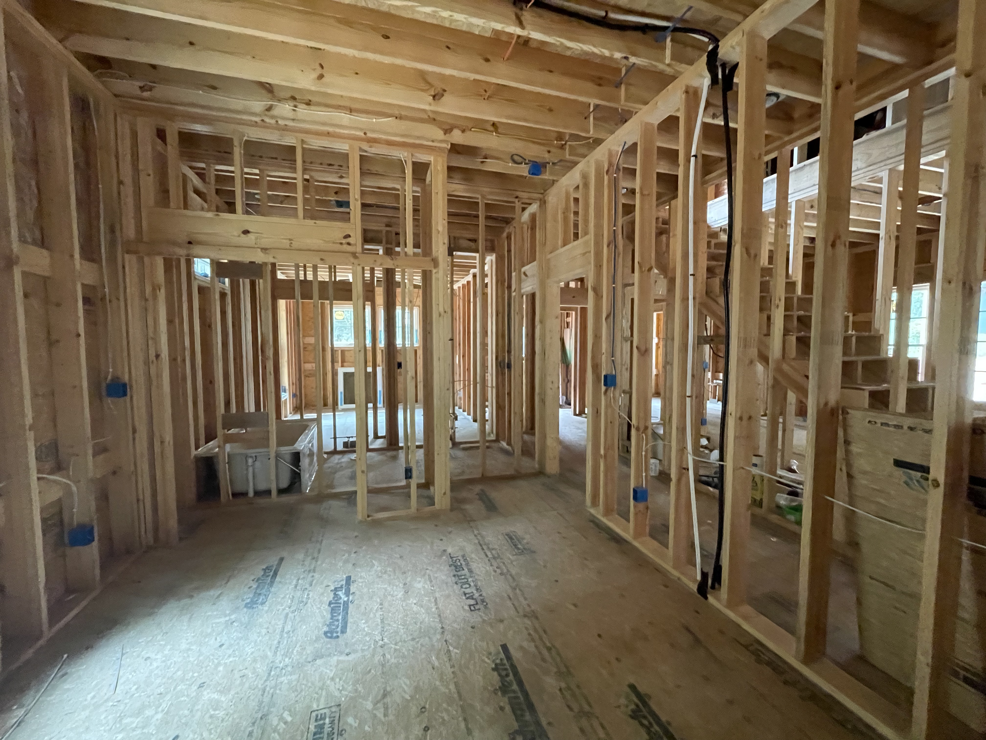Plumbing, electrical, and HVAC rough-in work inside a custom home in Southern Shores