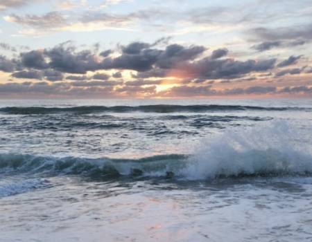 sunrise over a cloud-covered Atlantic Ocean off the OBX coast