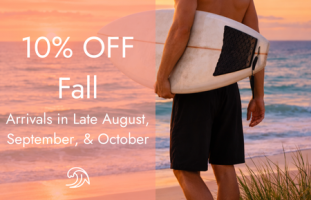 Surfer in black board shorts walking along the beach at sunset with text reading 10% Off Fall arrivals in Late August, September, and October.
