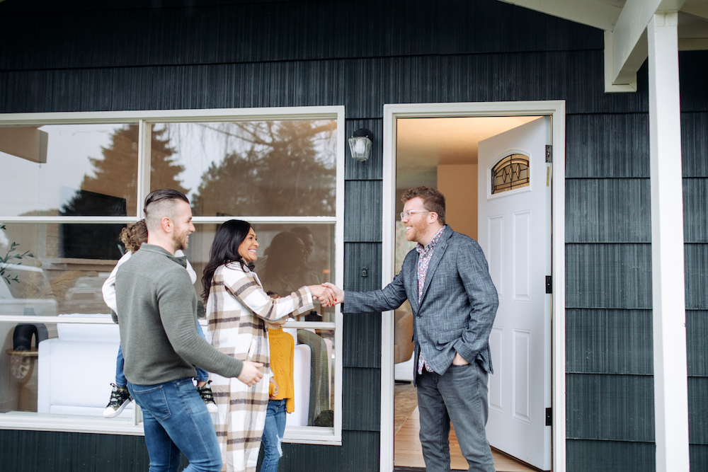 family meeting real estate agent outside a home