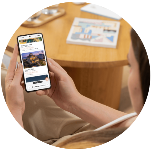 Person browsing Beach Realty Outer Banks vacation rentals on a phone